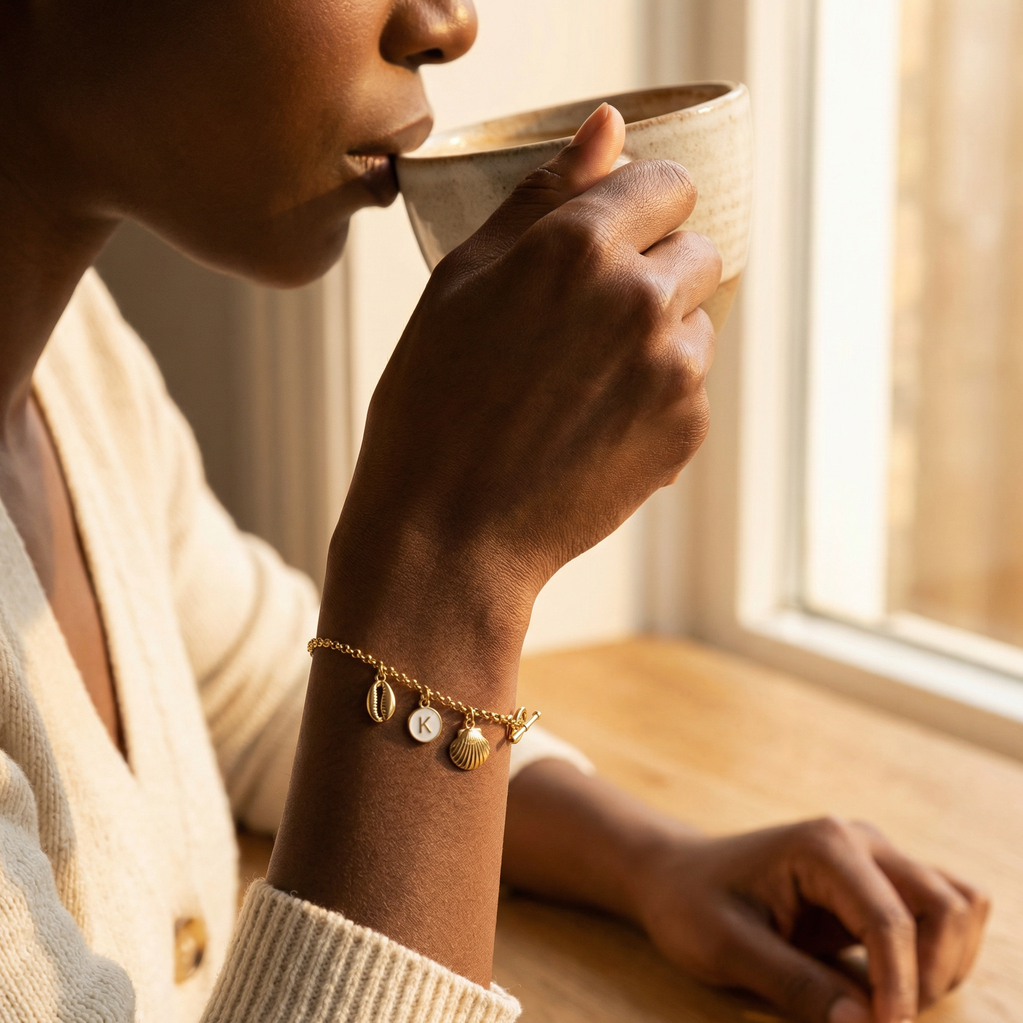 Seashell Charm Bracelet on Model - Sipping Coffee by Window