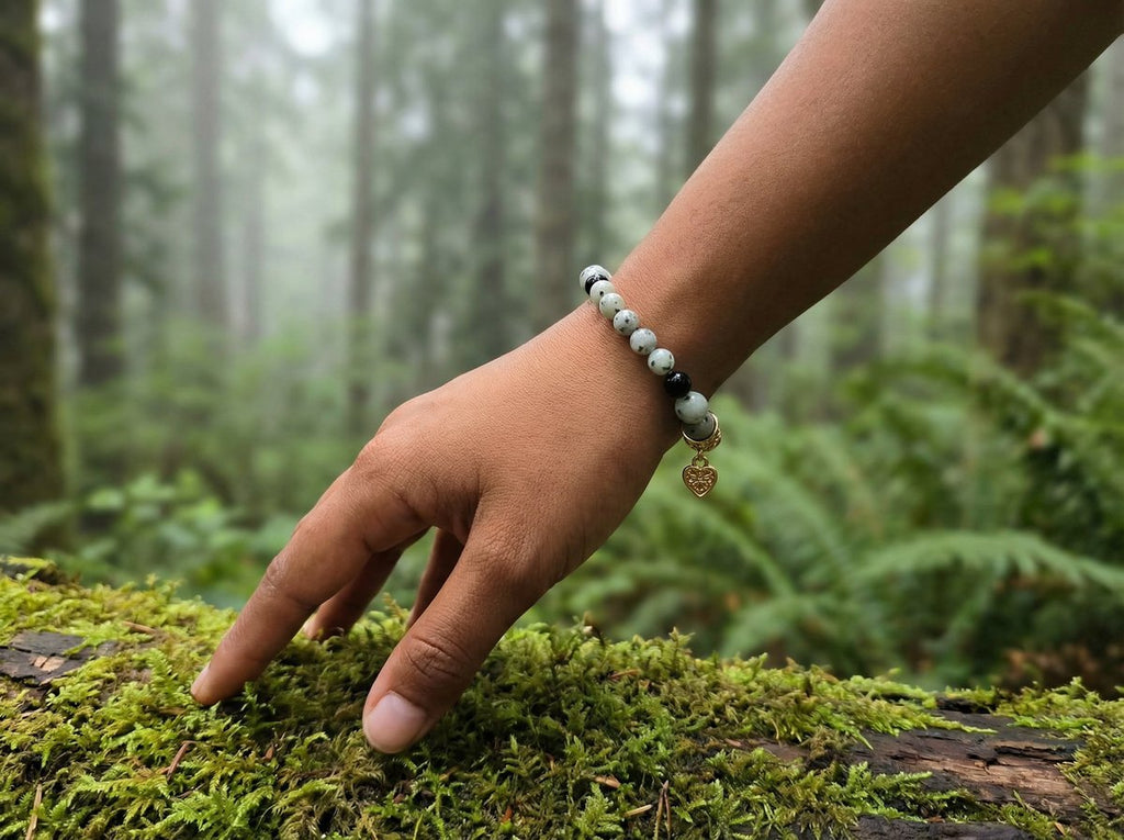 Sesame Jasper Heart Charm Bracelet on wrist in mossy Pacific Northwest forest