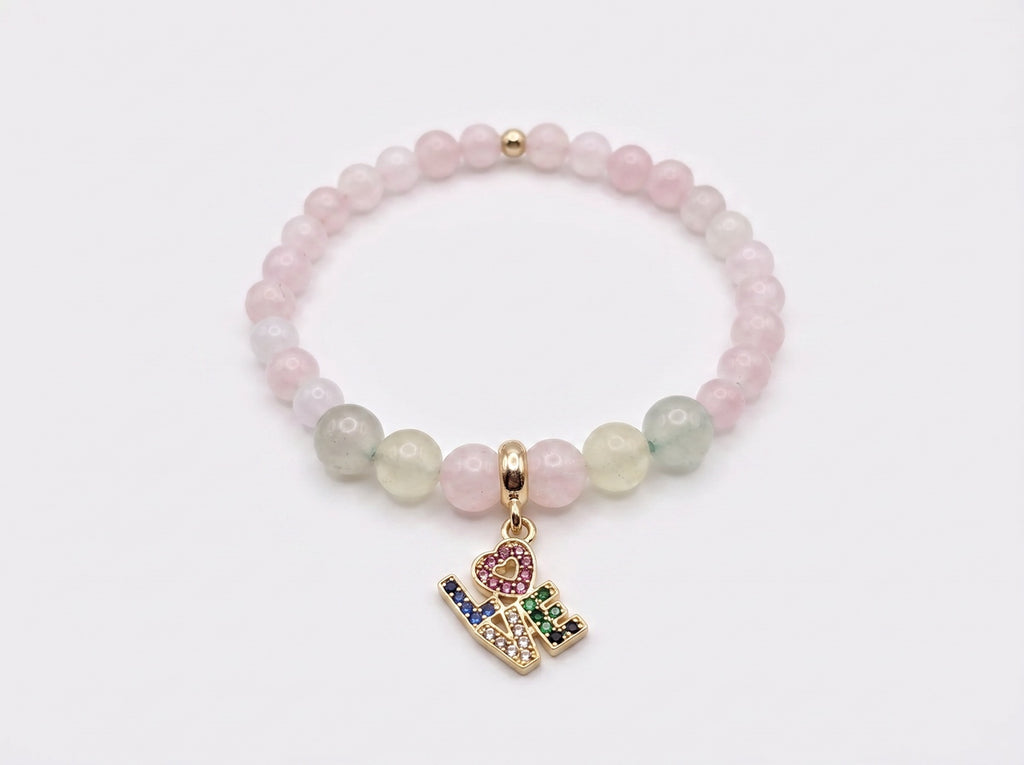 Rose Quartz and Prehnite LOVE Charm Bracelet flat lay on white background