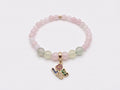 Rose Quartz and Prehnite LOVE Charm Bracelet flat lay on white background