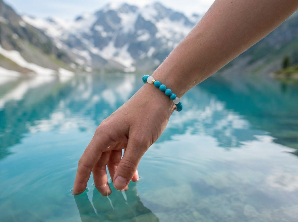 Turquoise and White Jade Bracelet on wrist with mountain lake backdrop